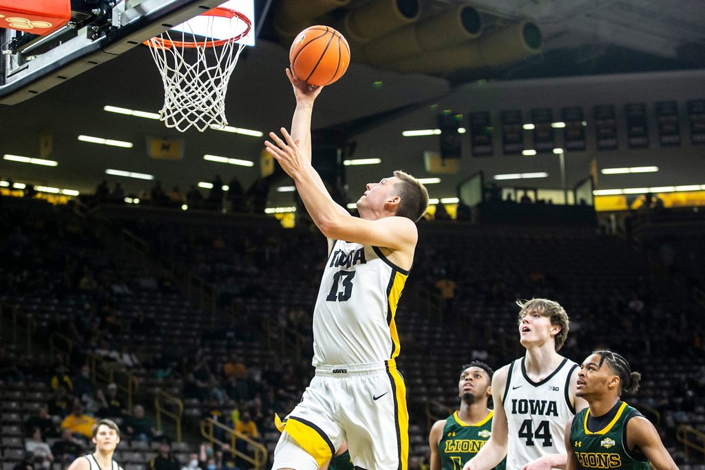 Iowa guard Austin Ash (13) makes a basket during a NCAA non-conference men's basketball game against Southeastern Louisiana, Tuesday, Dec. 21, 2021, at Carver-Hawkeye Arena in Iowa City, Iowa.
211221 Se Louisiana Iowa Mbb 037 Jpg