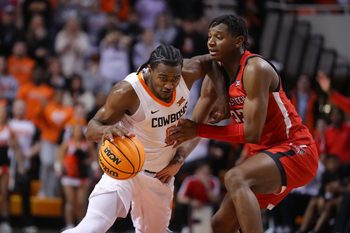 Oklahoma State Cowboys guard John-Michael Wright (51) is fouled by Texas Tech Red Raiders guard Elijah Fisher (22) during a men's college basketball game between the Oklahoma State University Cowboys (OSU) and the Texas Tech Red Raiders at Gallagher-Iba Arena in Stillwater, Okla., Wednesday, Feb. 8, 2023. Oklahoma State won 71-68.

Osu Vs Texas Tech Men S Basketball