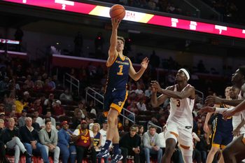 Nov 14, 2023; Los Angeles, California, USA; UC Irvine Anteaters guard Derin Saran (1) shoots the ball against Southern California Trojans forward Vincent Iwuchukwu (3) in the first half at Galen Center. Mandatory Credit: Kirby Lee-Imagn Images