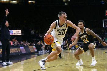 Iowa   s Payton Sandfort (20) drives toward the lane defended by UMBC's Marcus Banks Jr. (24) Wednesday, Dec. 20, 2023 at Carver-Hawkeye Arena in Iowa City, Iowa.
