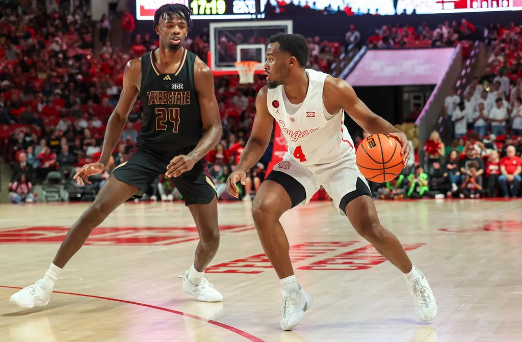 Dec 21, 2023; Houston, Texas, USA; Houston Cougars guard L.J. Cryer (4) dribbles against Texas State Bobcats forward Brandon Love (24) in the second half at Fertitta Center. Mandatory Credit: Thomas Shea-Imagn Images