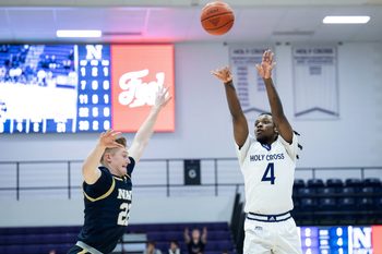 Holy Cross' Kahlil Singleton shoots as Navy's Mac MacDonald defends during Wednesday night's game at the Hart Center.