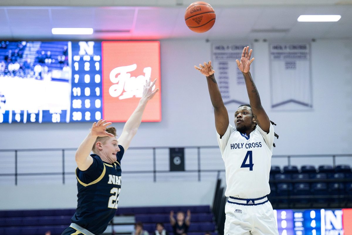 Holy Cross' Kahlil Singleton shoots as Navy's Mac MacDonald defends during Wednesday night's game at the Hart Center.