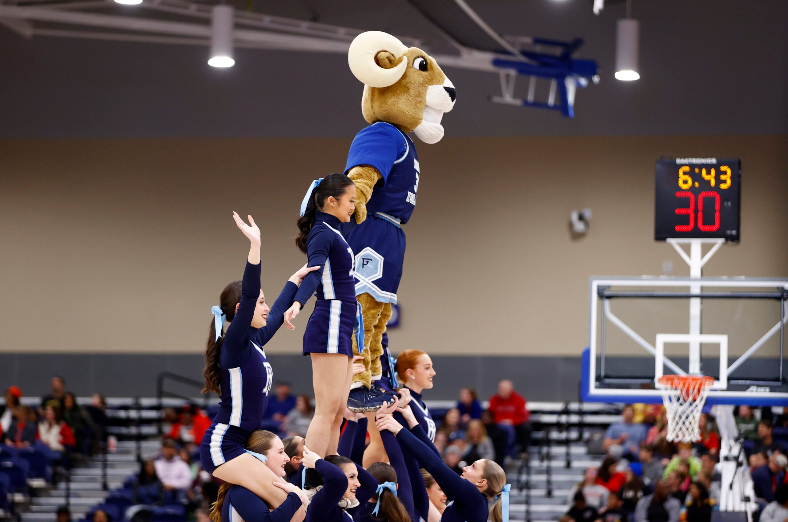 Mar 10, 2024; Henrico, VA, USA; Rhode Island Rams cheerleaders perform on the court during a stoppage in play in the first half at Henrico Sports & Events Center. Mandatory Credit: Amber Searls-Imagn Images