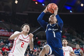 Mar 16, 2024; Atlantic City, NJ, USA; St. Peter's Peacocks guard Brent Bland (1) drives to the basket while being defended by Fairfield Stags guard Brycen Goodine (2) during the second half at Jim Whelan Boardwalk Hall. Mandatory Credit: John Jones-Imagn Images