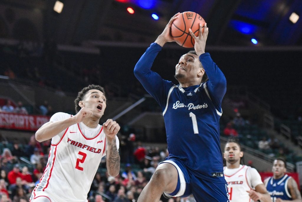 Mar 16, 2024; Atlantic City, NJ, USA; St. Peter's Peacocks guard Brent Bland (1) drives to the basket while being defended by Fairfield Stags guard Brycen Goodine (2) during the second half at Jim Whelan Boardwalk Hall. Mandatory Credit: John Jones-Imagn Images