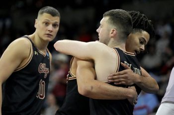 Mar 22, 2024; Spokane, WA, USA; Charleston Cougars forward Frankie Policelli (1) hugs guard CJ Fulton (12) during the second half in the first round of the 2024 NCAA Tournament against the Alabama Crimson Tide at Spokane Veterans Memorial Arena. Mandatory Credit: Kirby Lee-Imagn Images