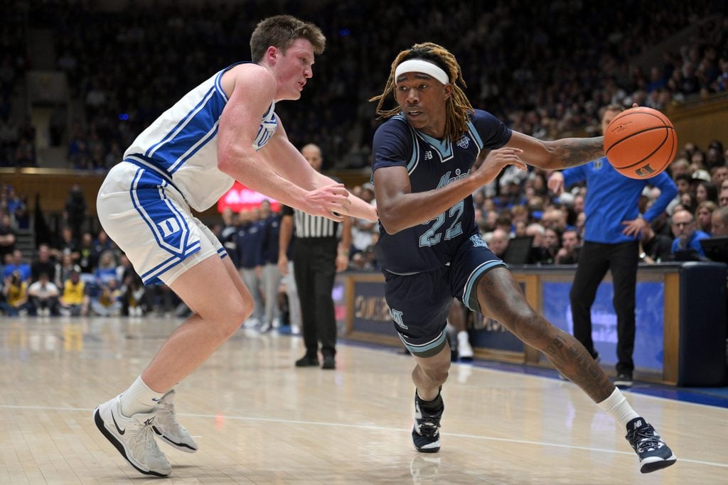Nov 4, 2024; Durham, North Carolina, USA; Maine Black Bears guard Quion Burns (22) drives the ball while under pressure from Duke Blue Devils guard Kon Knueppel (7) in the first half at Cameron Indoor Stadium. Mandatory Credit: Zachary Taft-Imagn Images