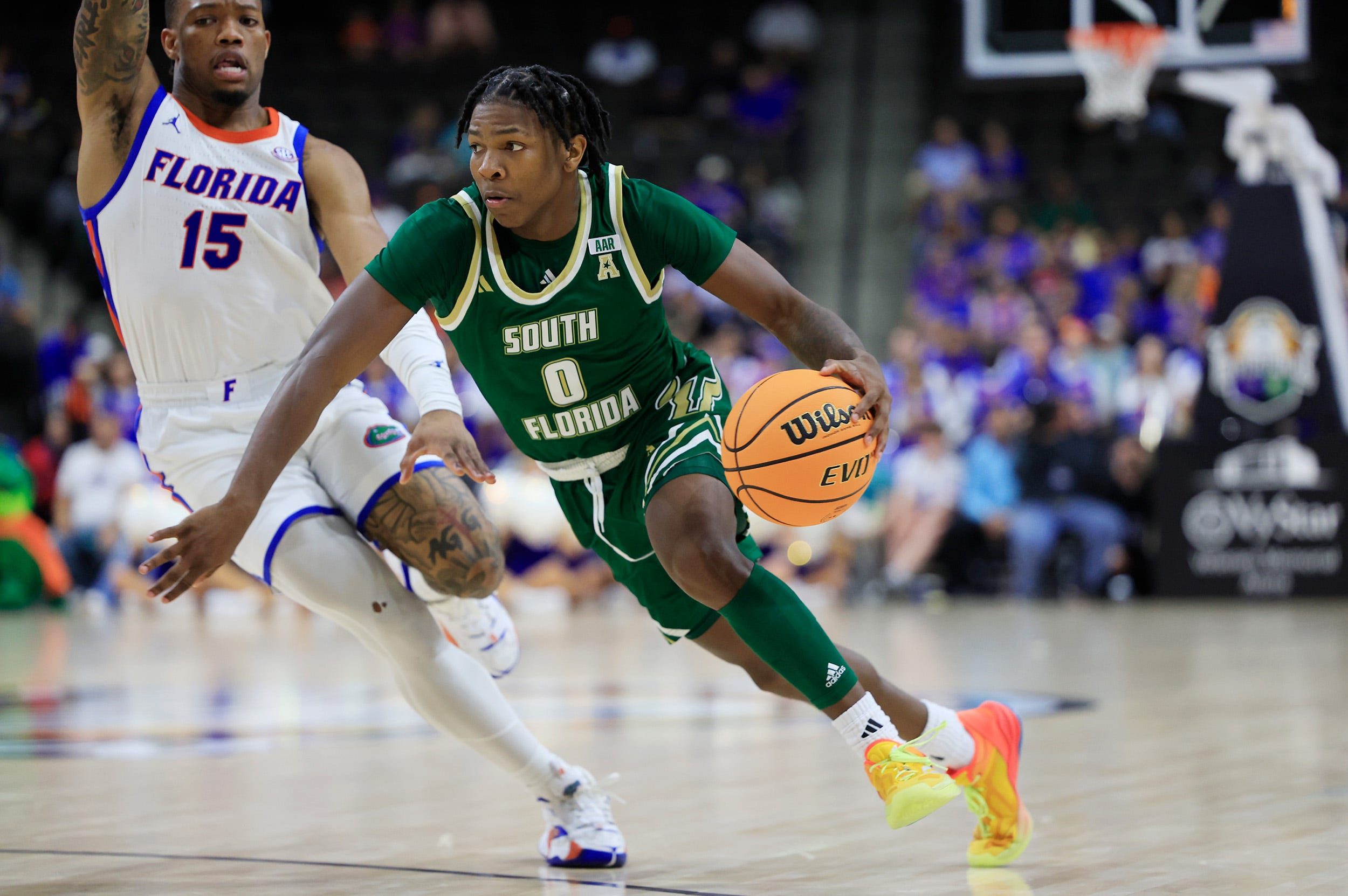 South Florida Bulls guard Jayden Reid (0) drives against Florida Gators guard Alijah Martin (15) during the second half of an NCAA men’s basketball matchup Monday, Nov. 4, 2024 at VyStar Veterans Memorial Arena in Jacksonville, Fla. Florida defeated South Florida 98-83. [Corey Perrine/Florida Times-Union]