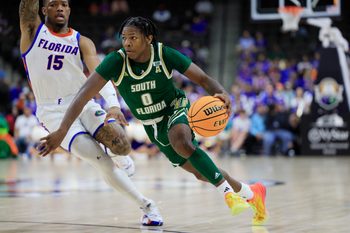 South Florida Bulls guard Jayden Reid (0) drives against Florida Gators guard Alijah Martin (15) during the second half of an NCAA men’s basketball matchup Monday, Nov. 4, 2024 at VyStar Veterans Memorial Arena in Jacksonville, Fla. Florida defeated South Florida 98-83. [Corey Perrine/Florida Times-Union]