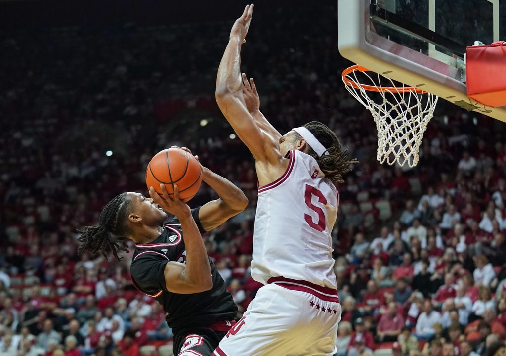 Nov 6, 2024; Bloomington, Indiana, USA; SIU Edwardsville Cougars guard Brian Taylor II (11) scores against Indiana Hoosiers forward Malik Reneau (5) during the second half at Simon Skjodt Assembly Hall. Mandatory Credit: Robert Goddin-Imagn Images