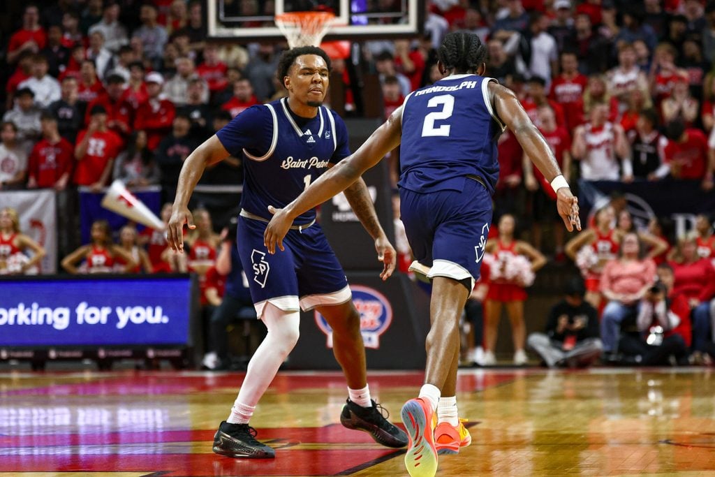 Nov 11, 2024; Piscataway, New Jersey, USA; St. Peter's Peacocks guard Marcus Randolph (2) celebrates after making a basket with guard Brent Bland (1) during the first half against the Rutgers Scarlet Knights at Jersey Mike's Arena. Mandatory Credit: Vincent Carchietta-Imagn Images