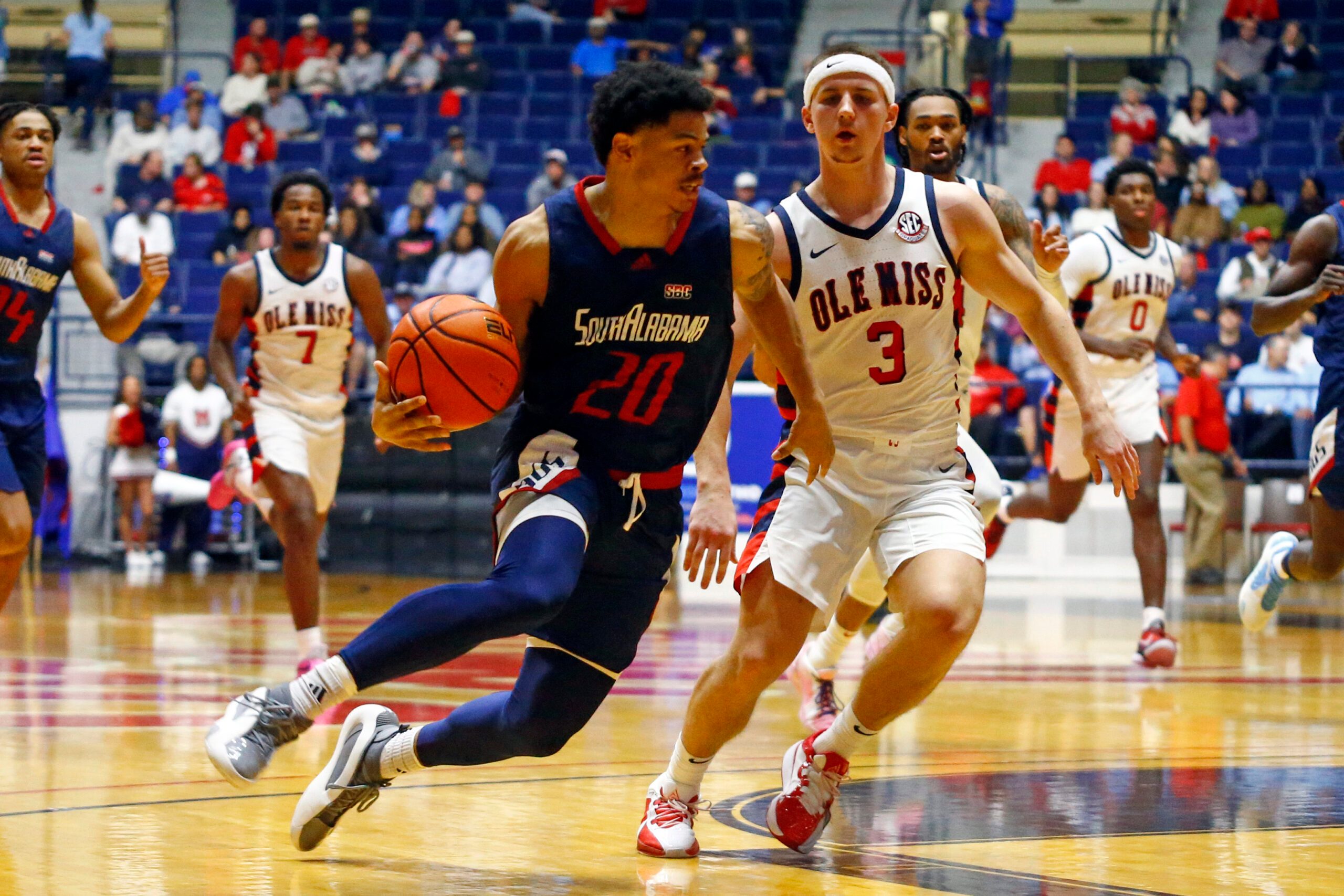 Nov 12, 2024; Oxford, Mississippi, USA; South Alabama Jaguars guard Myles Corey (20) drives to the basket as Mississippi Rebels guard Sean Pedulla (3) defends during the second half at C.M. 'Tad' Smith Coliseum. Mandatory Credit: Petre Thomas-Imagn Images