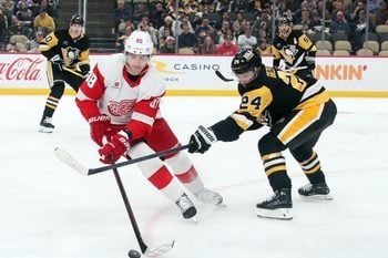 Nov 13, 2024; Pittsburgh, Pennsylvania, USA;  Detroit Red Wings right wing Patrick Kane (88) handles the puck against Pittsburgh Penguins defenseman Matt Grzelcyk (24) during the second period at PPG Paints Arena. Mandatory Credit: Charles LeClaire-Imagn Images