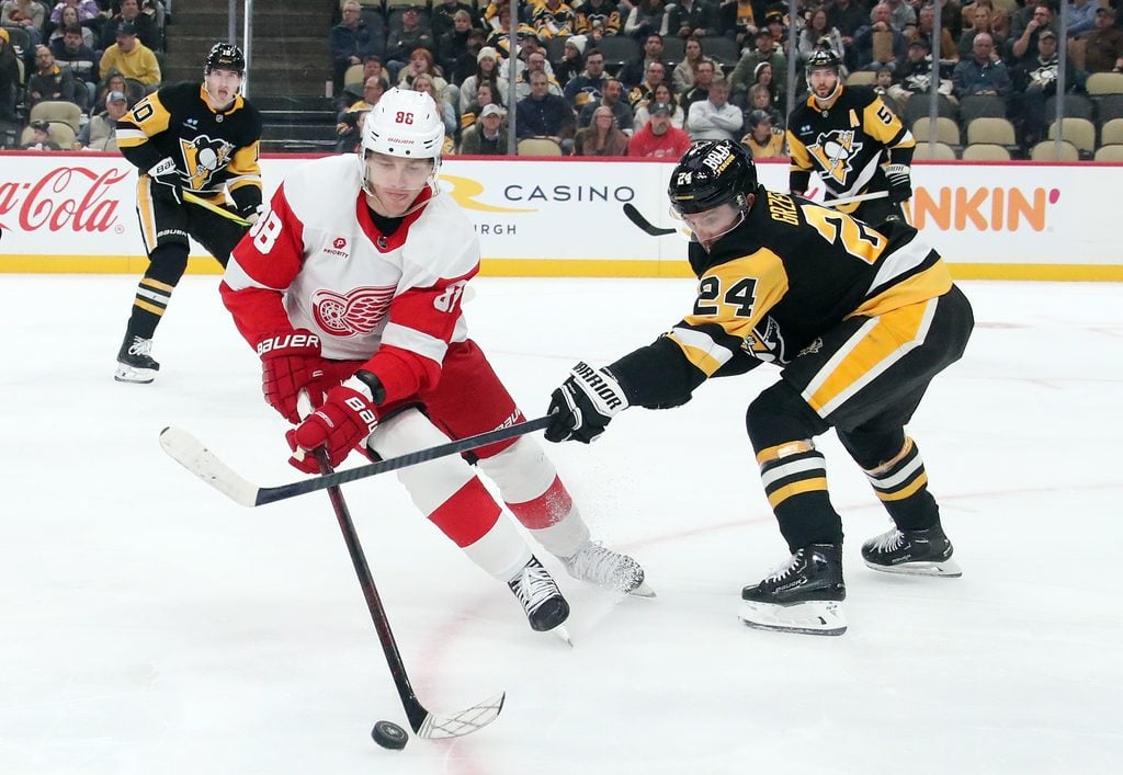 Nov 13, 2024; Pittsburgh, Pennsylvania, USA; Detroit Red Wings right wing Patrick Kane (88) handles the puck against Pittsburgh Penguins defenseman Matt Grzelcyk (24) during the second period at PPG Paints Arena. Mandatory Credit: Charles LeClaire-Imagn Images