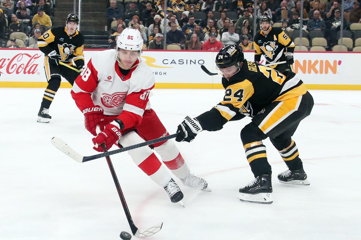 Nov 13, 2024; Pittsburgh, Pennsylvania, USA; Detroit Red Wings right wing Patrick Kane (88) handles the puck against Pittsburgh Penguins defenseman Matt Grzelcyk (24) during the second period at PPG Paints Arena. Mandatory Credit: Charles LeClaire-Imagn Images