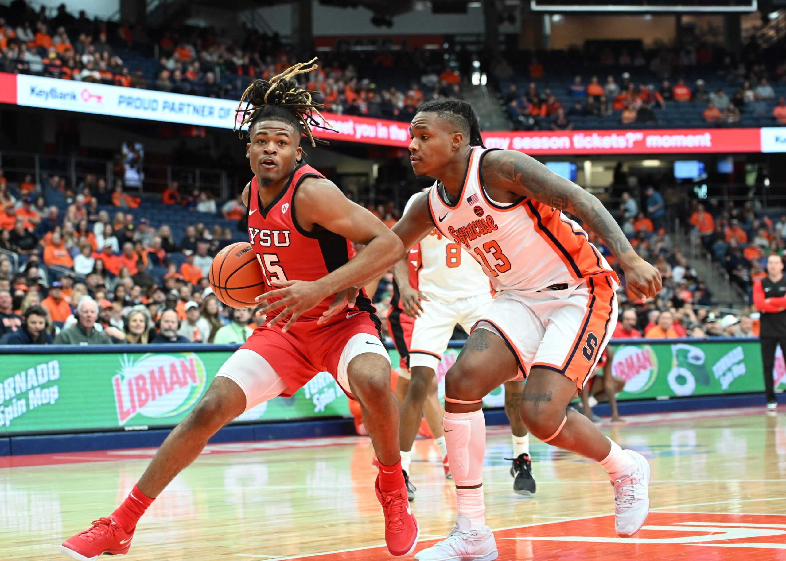 Nov 16, 2024; Syracuse, New York, USA; Youngstown State Penguins forward Cris Carroll (15) looks to the basket with Syracuse Orange forward Jyare Davis (13) defending in the first half at the JMA Wireless Dome. Mandatory Credit: Mark Konezny-Imagn Images