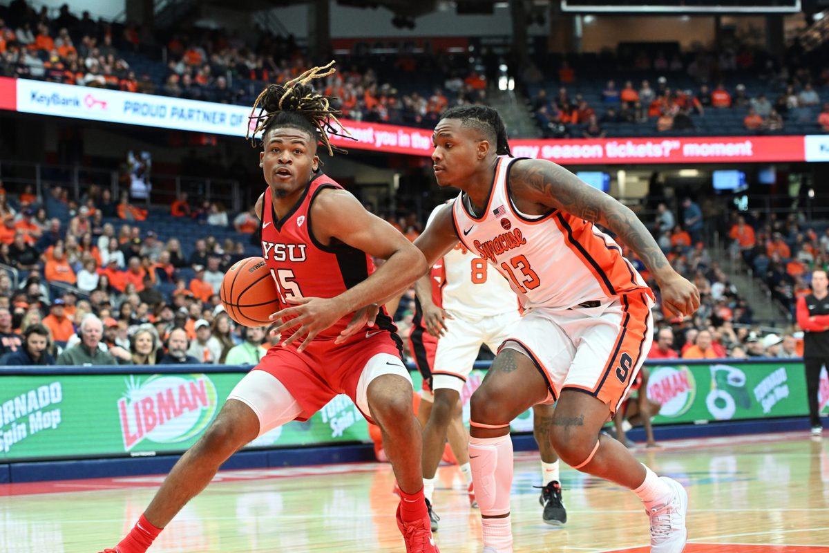 Nov 16, 2024; Syracuse, New York, USA; Youngstown State Penguins forward Cris Carroll (15) looks to the basket with Syracuse Orange forward Jyare Davis (13) defending in the first half at the JMA Wireless Dome. Mandatory Credit: Mark Konezny-Imagn Images