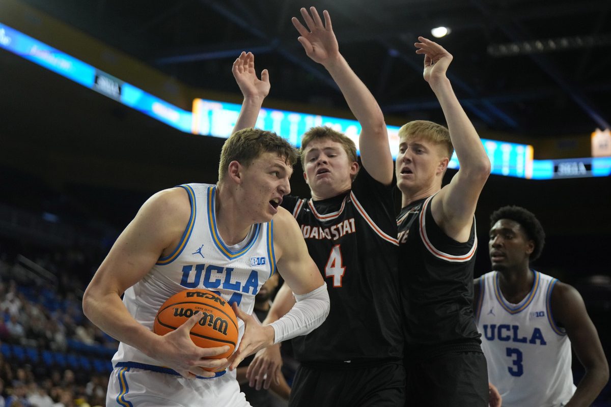 Nov 20, 2024; Los Angeles, California, USA; UCLA Bruins forward Tyler Bilodeau (34) is defended by Idaho State Bengals guard Jaedyn Brown (4) in the second half at Pauley Pavilion presented by Wescom. Mandatory Credit: Kirby Lee-Imagn Images