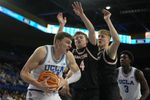 Nov 20, 2024; Los Angeles, California, USA; UCLA Bruins forward Tyler Bilodeau (34) is defended by Idaho State Bengals guard Jaedyn Brown (4) in the second half at Pauley Pavilion presented by Wescom. Mandatory Credit: Kirby Lee-Imagn Images