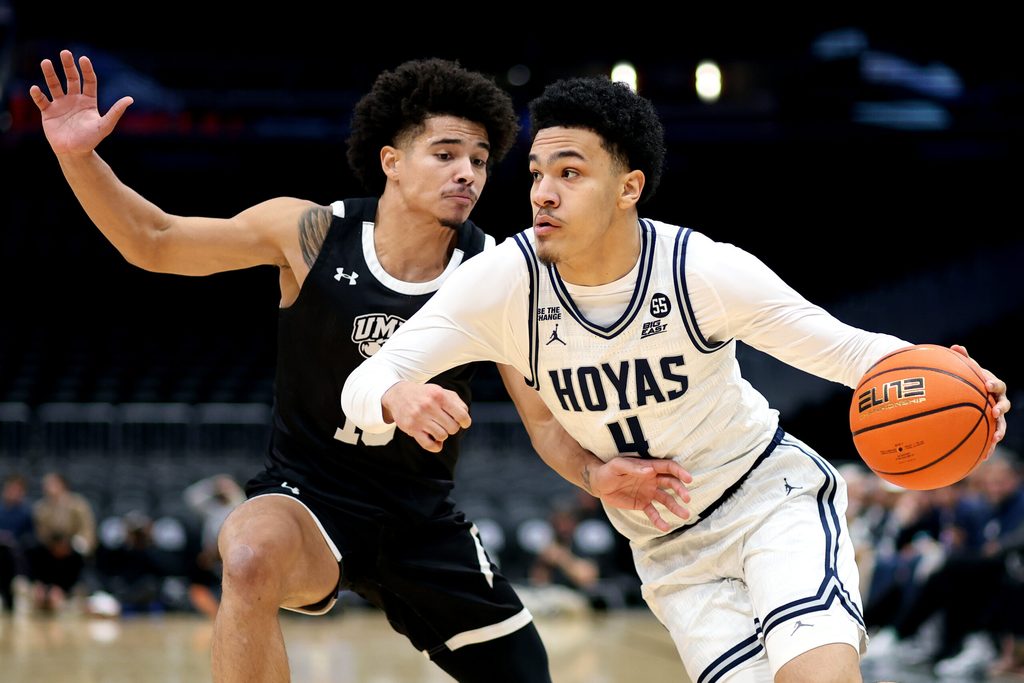 Dec 2, 2024; Washington, District of Columbia, USA; Georgetown Hoyas forward Caleb Williams (4) drives past UMBC Retrievers guard Devan Sapp (10) during the first half at Capital One Arena. Mandatory Credit: Daniel Kucin Jr.-Imagn Images