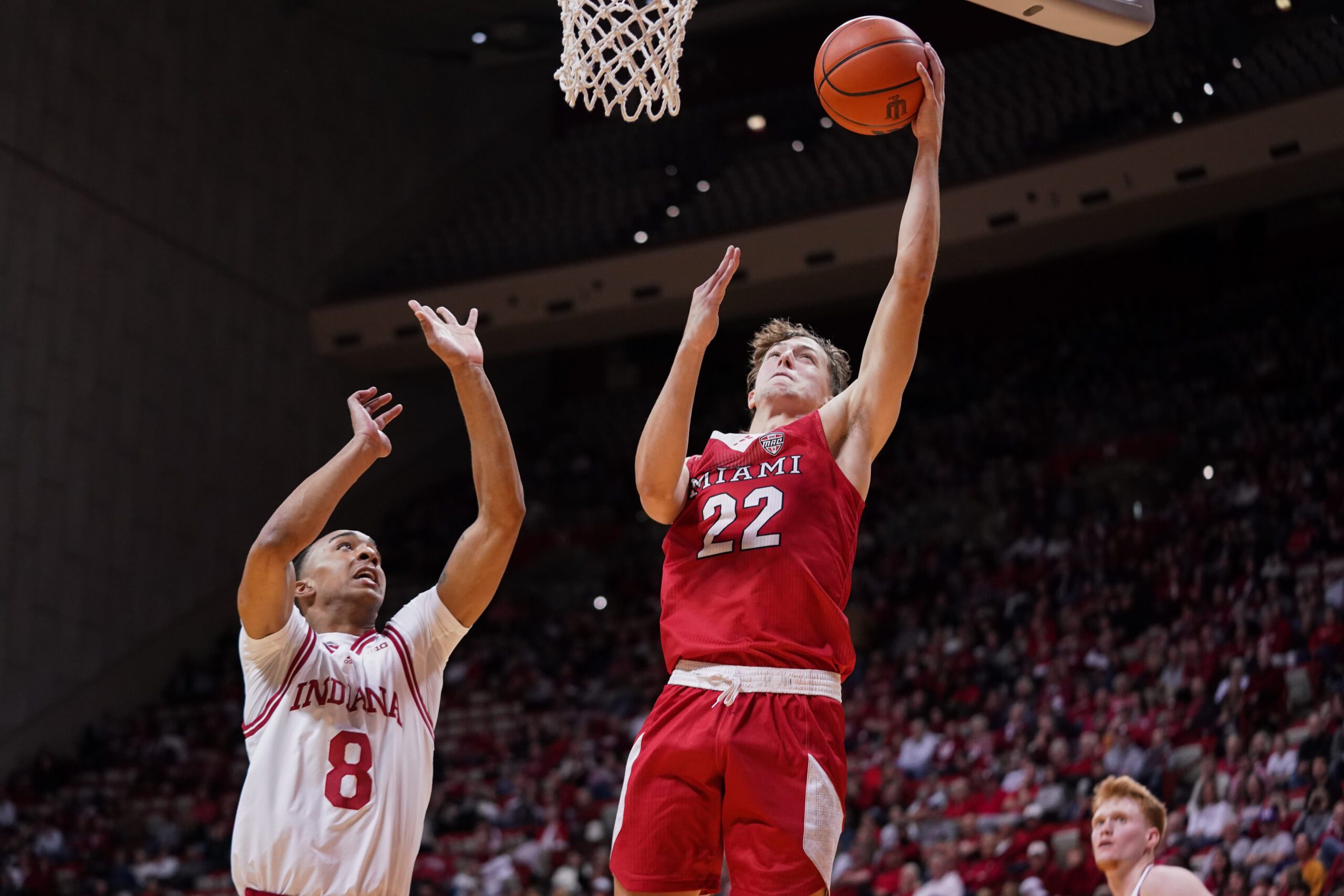 Dec 6, 2024; Bloomington, Indiana, USA;  Miami (Oh) Redhawks forward Brant Byers (22) scores past Indiana Hoosiers forward Bryson Tucker (8) during the second half at Simon Skjodt Assembly Hall. Mandatory Credit: Robert Goddin-Imagn Images