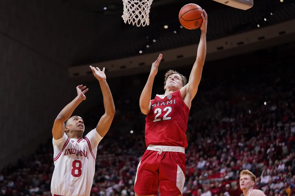 Dec 6, 2024; Bloomington, Indiana, USA; Miami (Oh) Redhawks forward Brant Byers (22) scores past Indiana Hoosiers forward Bryson Tucker (8) during the second half at Simon Skjodt Assembly Hall. Mandatory Credit: Robert Goddin-Imagn Images