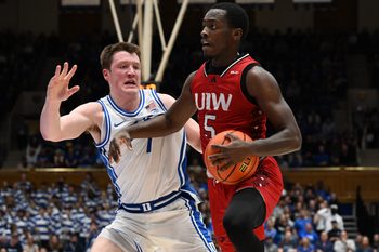 Dec 10, 2024; Durham, North Carolina, USA;  dIncarnate Word Cardinals guard Davion Bailey (5) drives to the basket as Duke Blue Devils forward Kon Knueppel (7) defends during the first half at Cameron Indoor Stadium. Mandatory Credit: Rob Kinnan-Imagn Images