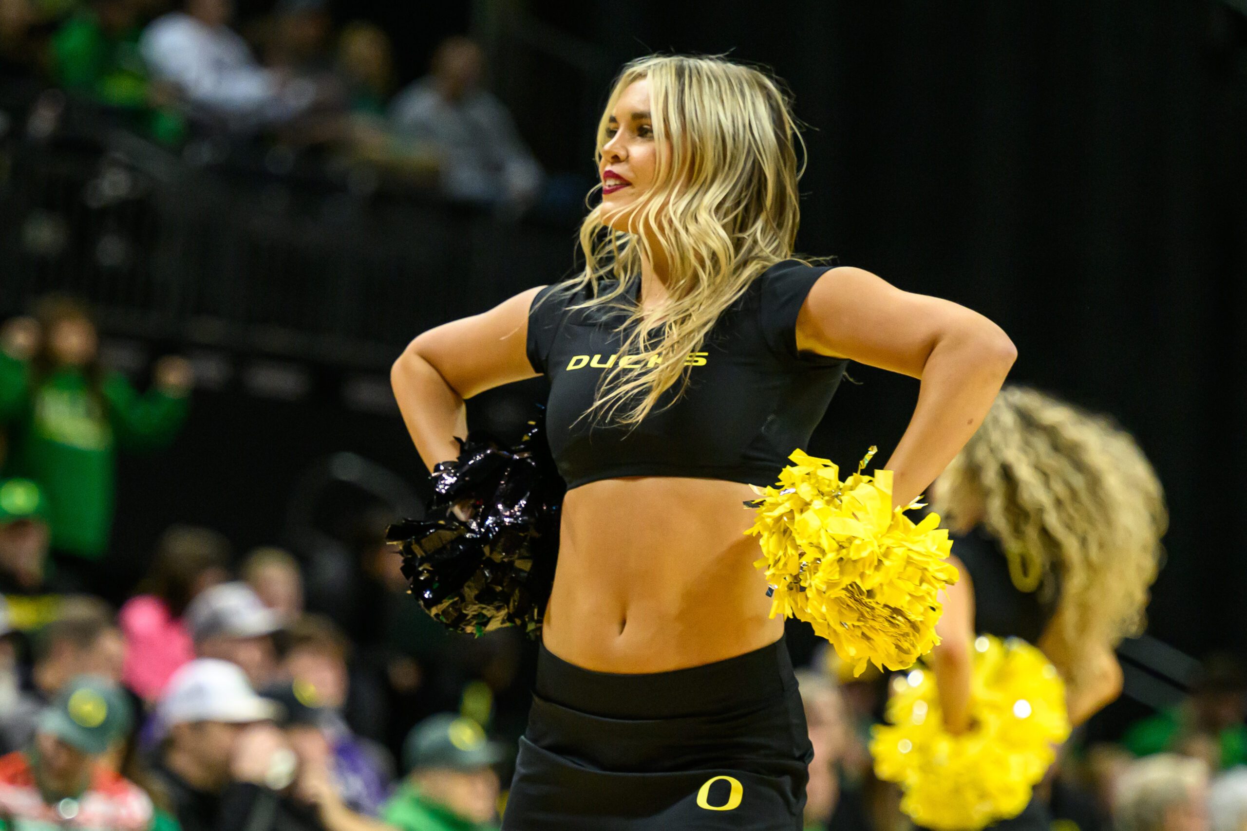 Dec 15, 2024; Eugene, Oregon, USA; Oregon Ducks cheerleader performs during the second half against the Stephen F. Austin Lumberjacks at Matthew Knight Arena. Mandatory Credit: Craig Strobeck-Imagn Images