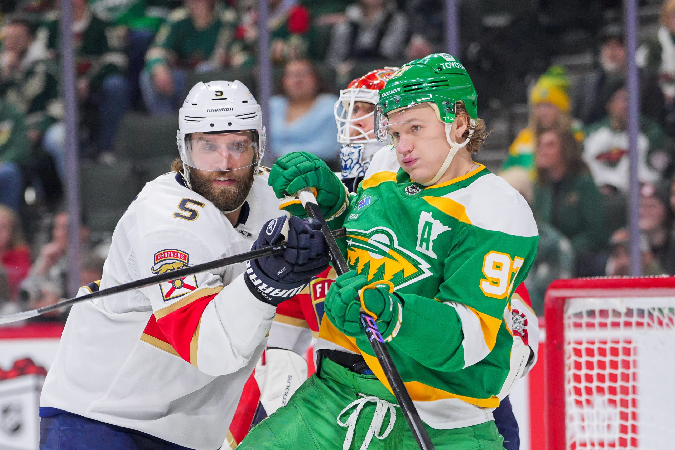 Dec 18, 2024; Saint Paul, Minnesota, USA;  Florida Panthers defenseman Aaron Ekblad (5) defends Minnesota Wild left wing Kirill Kaprizov (97) in the second period at Xcel Energy Center. Mandatory Credit: Brad Rempel-Imagn Images