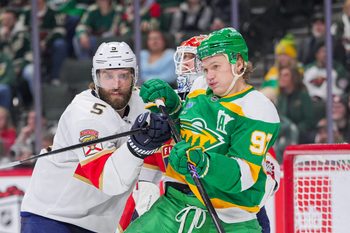 Dec 18, 2024; Saint Paul, Minnesota, USA;  Florida Panthers defenseman Aaron Ekblad (5) defends Minnesota Wild left wing Kirill Kaprizov (97) in the second period at Xcel Energy Center. Mandatory Credit: Brad Rempel-Imagn Images