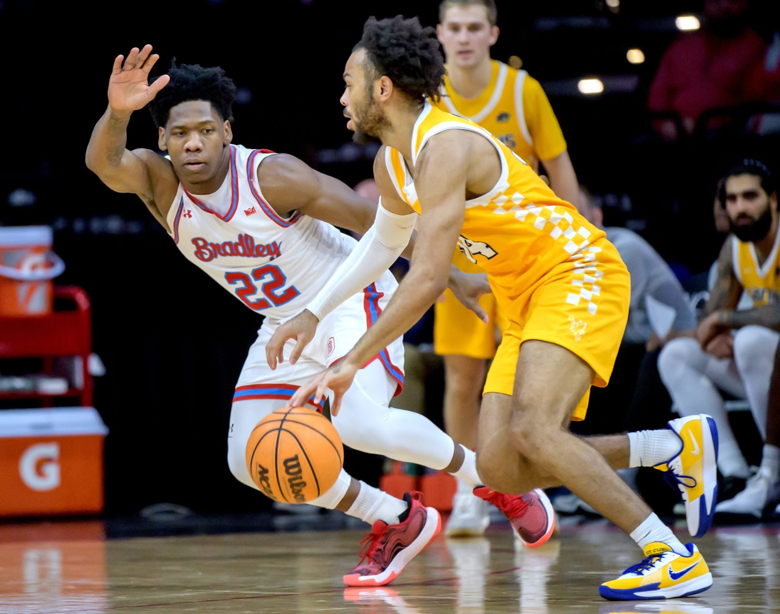 Bradley’s Jaquan Johnson (22) defends against Canisius’ Paul McMillan IV in the second half of their college basketball game Saturday, Dec. 21, 2024 at Carver Arena. The Braves routed the Golden Griffins 92-59.