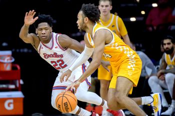 Bradley’s Jaquan Johnson (22) defends against Canisius’ Paul McMillan IV in the second half of their college basketball game Saturday, Dec. 21, 2024 at Carver Arena. The Braves routed the Golden Griffins 92-59.