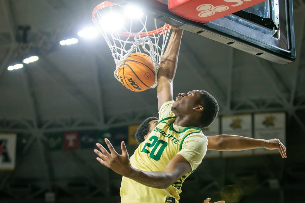 Jan 14, 2025; Wichita, Kansas, USA; Charlotte 49ers forward Robert Braswell IV (20) dunks during the first half against the Wichita State Shockers at Charles Koch Arena. Mandatory Credit: William Purnell-Imagn Images