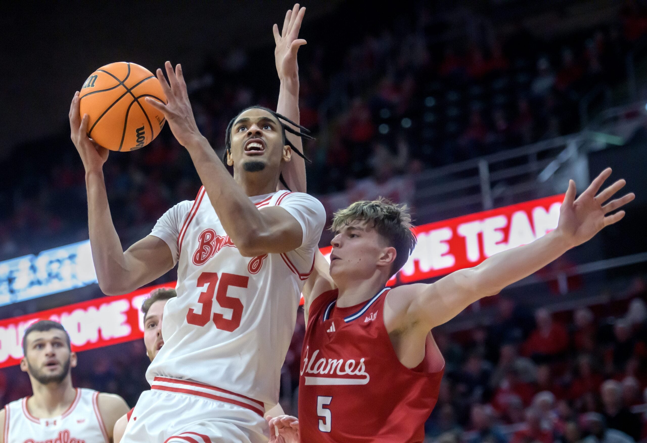 Bradley’s Darius Hannah (35) gets past UIC’s Modestas Kancleris in the second half of their MVC basketball game Wednesday, Jan. 29, 2025 at Carver Arena in Peoria. The Braves fell 93-70 to the Flames.