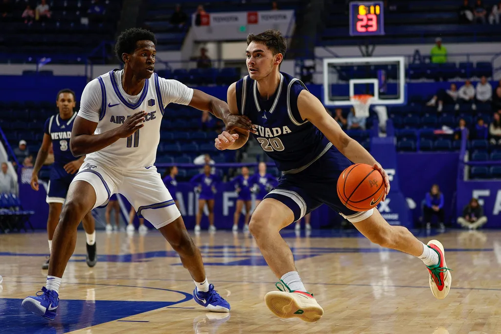 Feb 4, 2025; Colorado Springs, Colorado, USA; Nevada Wolf Pack guard Daniel Foster (20) controls the ball as Air Force Falcons guard Byron Brown (11) guards in the second half at Clune Arena. Mandatory Credit: Isaiah J. Downing-Imagn Images
