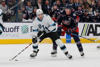 Feb 6, 2025; Columbus, Ohio, USA; Utah Hockey Club center Nick Schmaltz (8) passes against Columbus Blue Jackets left wing Dmitri Voronkov (10) during the first period at Nationwide Arena. Mandatory Credit: Russell LaBounty-Imagn Images