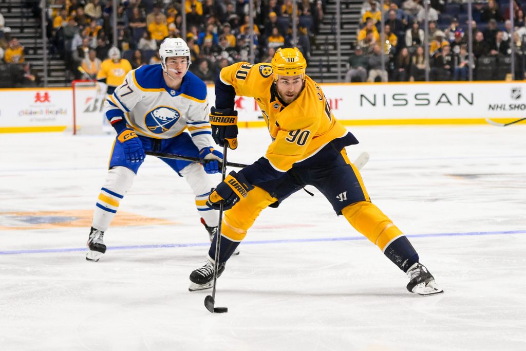 Feb 8, 2025; Nashville, Tennessee, USA; Nashville Predators center Ryan O'Reilly (90) skates with the puck against the Buffalo Sabres during the third period at Bridgestone Arena. Mandatory Credit: Steve Roberts-Imagn Images
