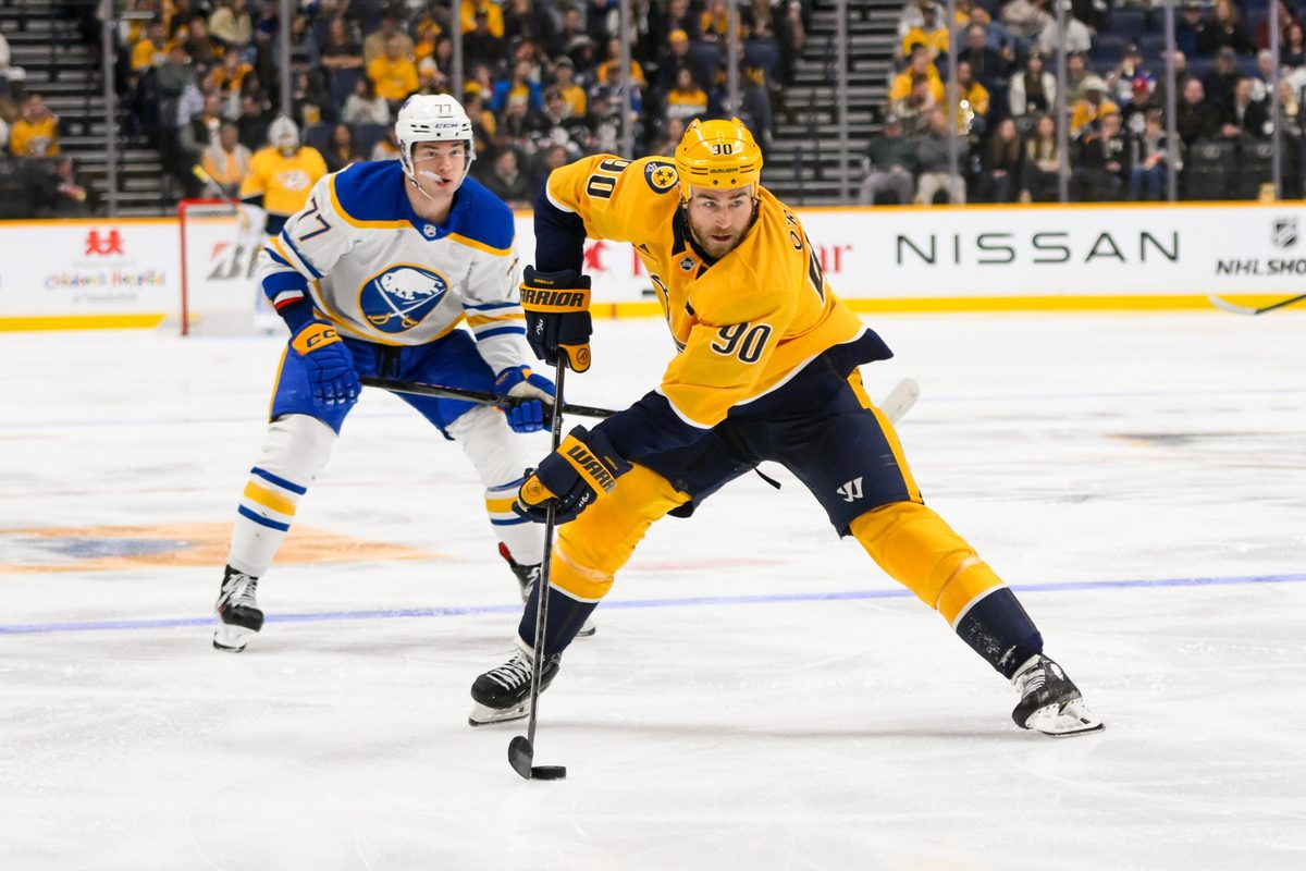 Feb 8, 2025; Nashville, Tennessee, USA; Nashville Predators center Ryan O'Reilly (90) skates with the puck against the Buffalo Sabres during the third period at Bridgestone Arena. Mandatory Credit: Steve Roberts-Imagn Images