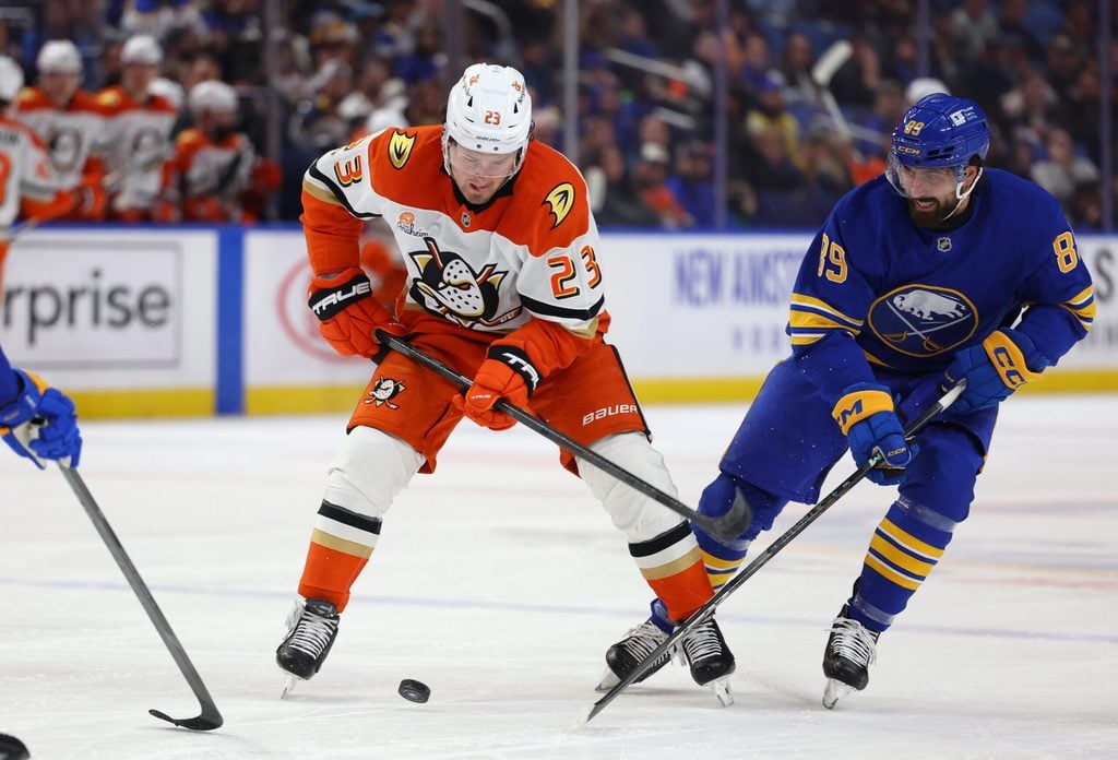 Feb 25, 2025; Buffalo, New York, USA; Anaheim Ducks center Mason McTavish (23) and Buffalo Sabres right wing Alex Tuch (89) go after a loose puck during the first period at KeyBank Center. Mandatory Credit: Timothy T. Ludwig-Imagn Images