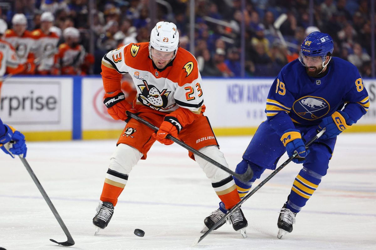 Feb 25, 2025; Buffalo, New York, USA; Anaheim Ducks center Mason McTavish (23) and Buffalo Sabres right wing Alex Tuch (89) go after a loose puck during the first period at KeyBank Center. Mandatory Credit: Timothy T. Ludwig-Imagn Images