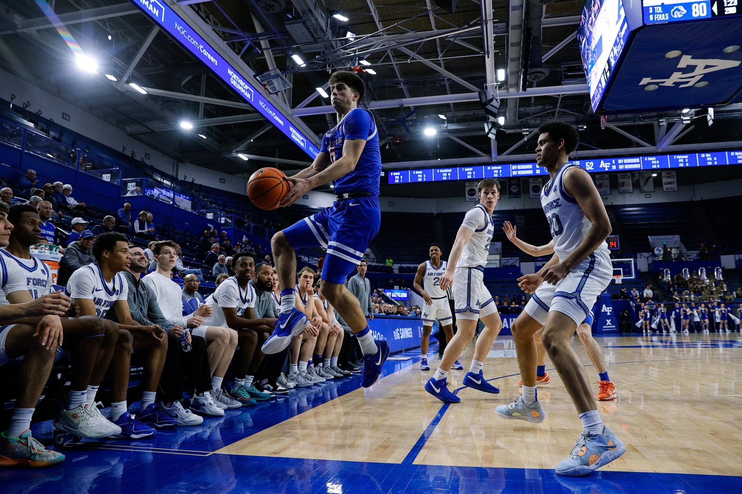 Mar 4, 2025; Colorado Springs, Colorado, USA; Boise State Broncos forward Pearson Carmichael (6) attempts to keep the ball inbounds as Air Force Falcons guard Yoda Oke (20) and guard Sam Duskin (23) look on in the second half at Clune Arena. Mandatory Credit: Isaiah J. Downing-Imagn Images