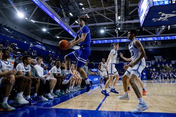 Mar 4, 2025; Colorado Springs, Colorado, USA; Boise State Broncos forward Pearson Carmichael (6) attempts to keep the ball inbounds as Air Force Falcons guard Yoda Oke (20) and guard Sam Duskin (23) look on in the second half at Clune Arena. Mandatory Credit: Isaiah J. Downing-Imagn Images
