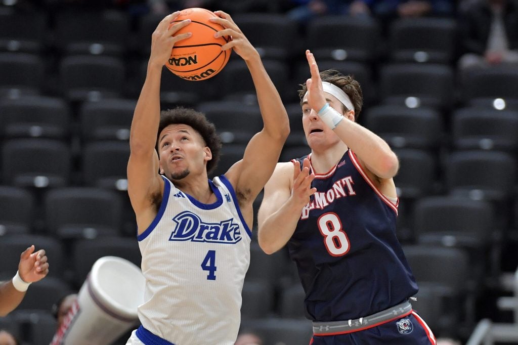 Mar 8, 2025; St. Louis, MO, Drake Bulldogs guard Isaiah Jackson (4) pulls a rebound away from Belmont Bruins guard Tyler Lundblade (8) during the first half at Enterprise Center. Mandatory Credit: Ron Johnson-Imagn Images