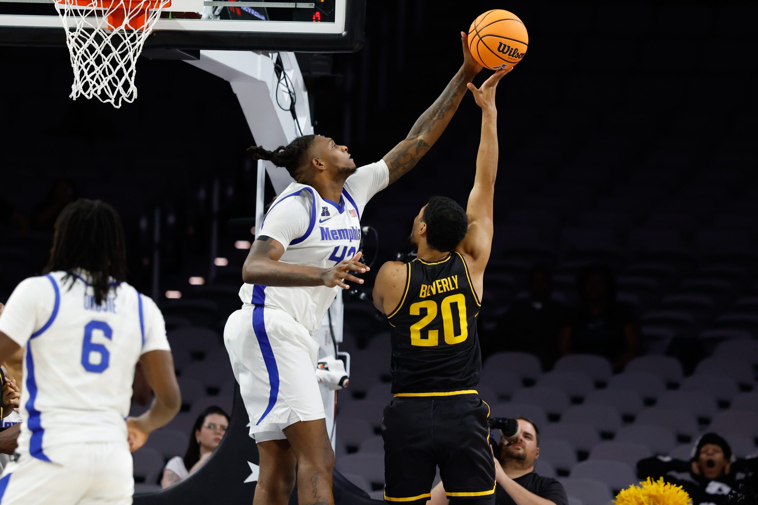 Mar 14, 2025; Fort Worth, TX, USA;  Wichita State Shockers guard Harlond Beverly (20) has his shot blocked by Memphis Tigers forward Dain Dainja (42) during the second half at Dickies Arena. Mandatory Credit: Chris Jones-Imagn Images