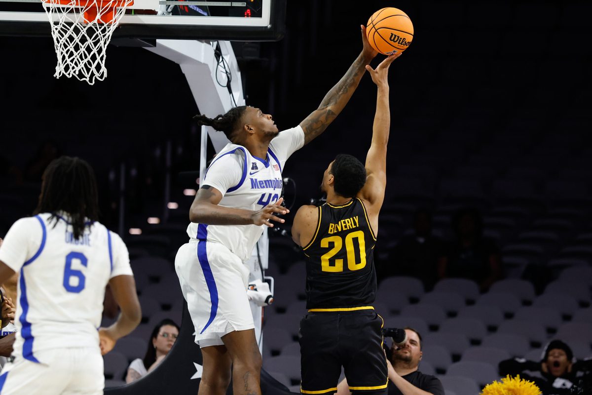 Mar 14, 2025; Fort Worth, TX, USA; Wichita State Shockers guard Harlond Beverly (20) has his shot blocked by Memphis Tigers forward Dain Dainja (42) during the second half at Dickies Arena. Mandatory Credit: Chris Jones-Imagn Images