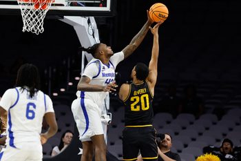 Mar 14, 2025; Fort Worth, TX, USA;  Wichita State Shockers guard Harlond Beverly (20) has his shot blocked by Memphis Tigers forward Dain Dainja (42) during the second half at Dickies Arena. Mandatory Credit: Chris Jones-Imagn Images