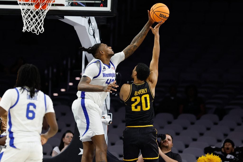 Mar 14, 2025; Fort Worth, TX, USA; Wichita State Shockers guard Harlond Beverly (20) has his shot blocked by Memphis Tigers forward Dain Dainja (42) during the second half at Dickies Arena. Mandatory Credit: Chris Jones-Imagn Images