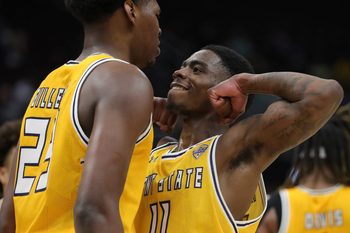 Kent State Golden Flashes guard Cian Medley (11) celebrates with forward Delrecco Gillespie (23) during the second half of an NCAA college basketball game in the semifinals of the Mid-American Conference Tournament at Rocket Arena on Friday, March 14, 2025, in Cleveland, Ohio.