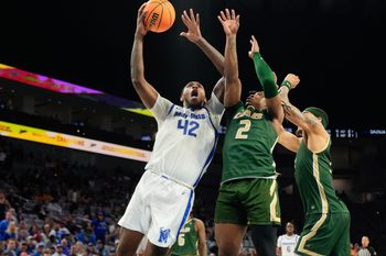 Mar 16, 2025; Fort Worth, TX, USA; Memphis Tigers forward Dain Dainja (42) scores a basket against UAB Blazers guard Ja'Borri McGhee (2) during the second half at Dickies Arena. Mandatory Credit: Chris Jones-Imagn Images